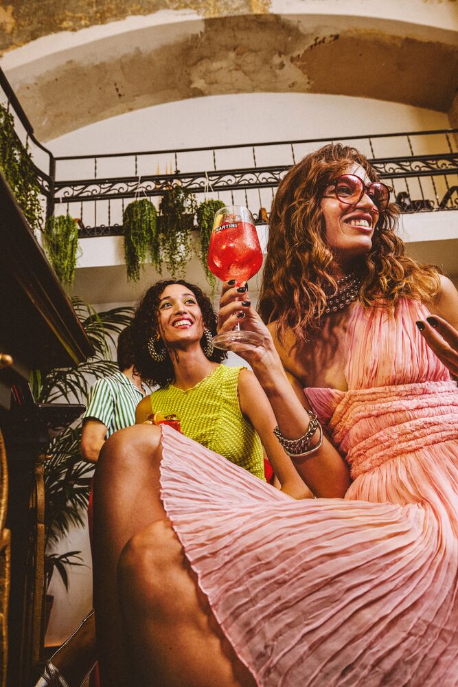 Image of a garden setting laid out for an aperitivo, referencing the below suggestions - lighting and warmth.